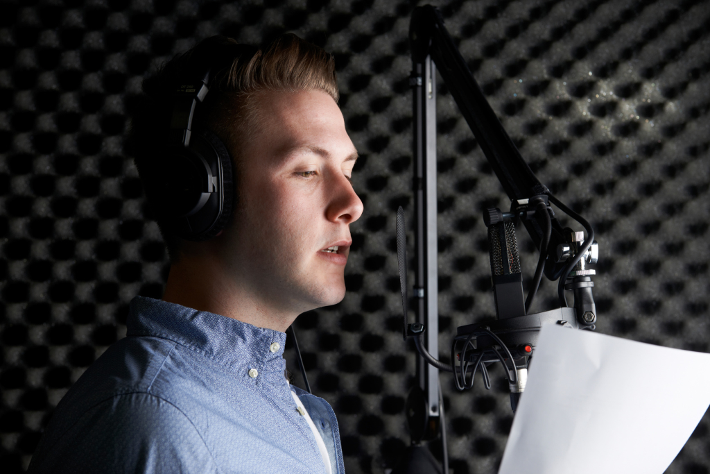 Man In Recording Studio Talking Into Microphone