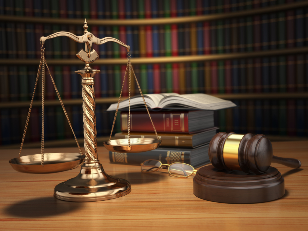 Justice concept. Gavel, golden scales and books in the library with dof effect. 3d